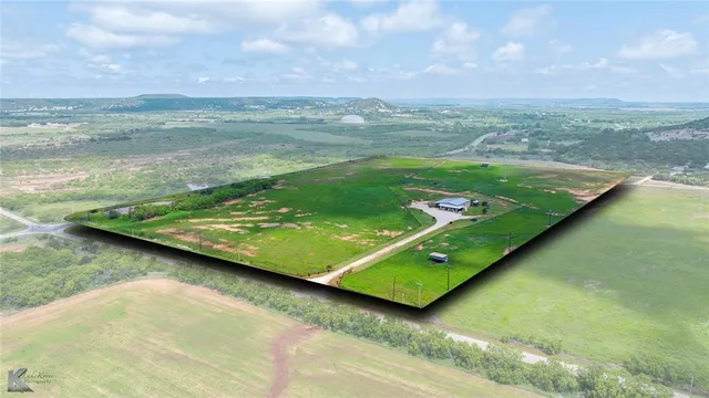 a view of a pool with a yard and mountain in the back