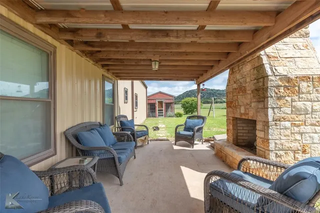 a living room with furniture a fireplace and a table