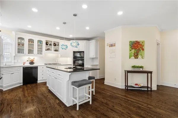 a kitchen with a stove a window cabinets and a counter top space