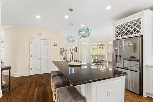 a view of a hallway with wooden floor and furniture