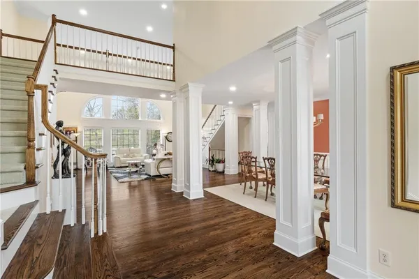 a view of an entryway with wooden floor and a chandelier