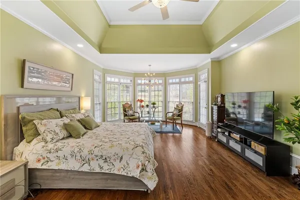 a bedroom with a bed and a painting on the wall