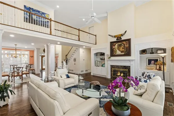 a living room with furniture fireplace and a view of kitchen