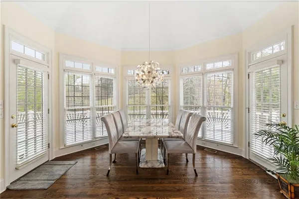 a aerial view of a house with a yard and a large tree