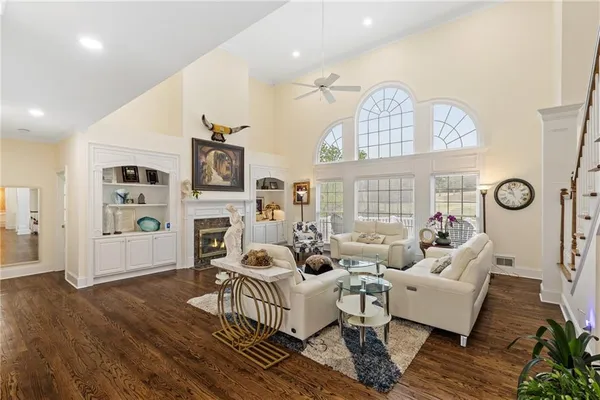 a living room with fireplace furniture and a wooden floor