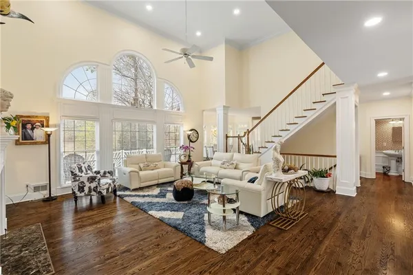 a living room with furniture or wooden floor and a large window