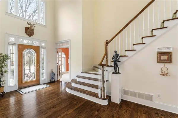 a view of entryway with wooden floor and stairs
