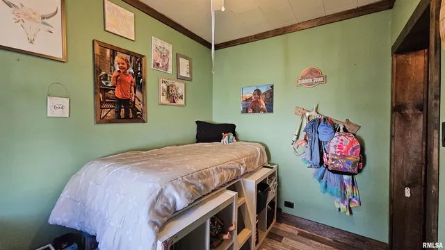 a bedroom with a bed and painting on the wall