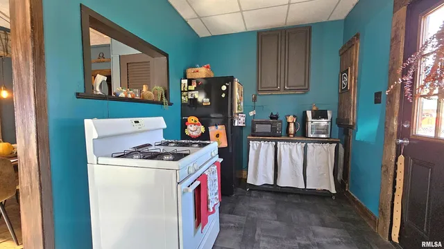 a kitchen with stainless steel appliances granite countertop a refrigerator and a stove