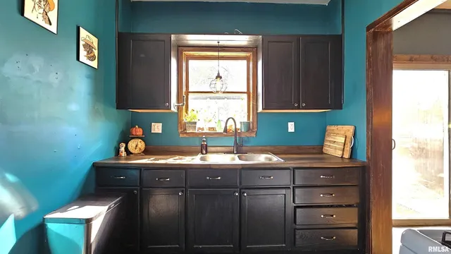 a kitchen with a sink cabinets and window