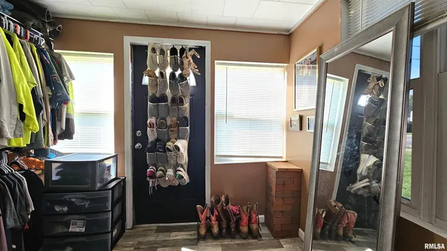 a view of walk in closet with clothes and shoes