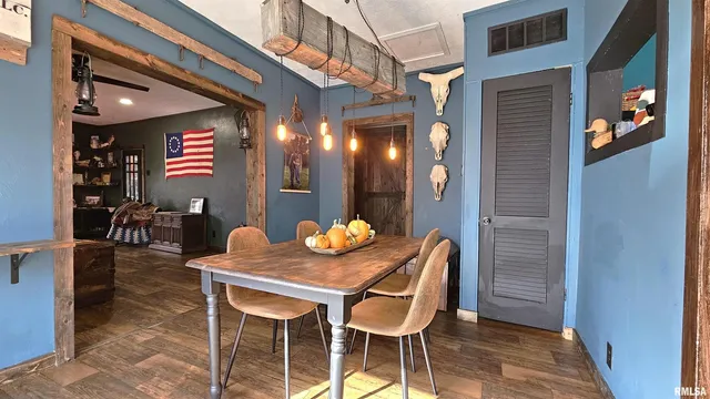 a dining room with furniture and wooden floor