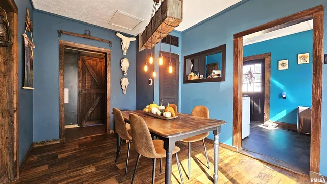 a dining room with furniture and wooden floor