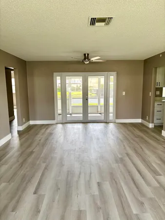 wooden floor in an empty room with a window