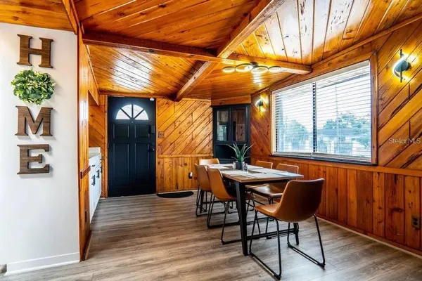 a view of a dining room with furniture window and wooden floor