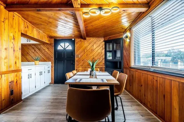 a living room with furniture and wooden floors