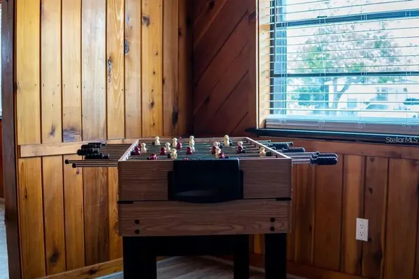 a view of a workspace with furniture and a window