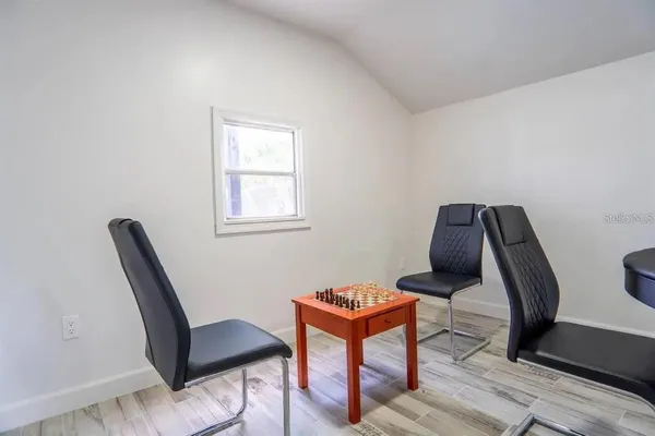 a bedroom with a bed and windows