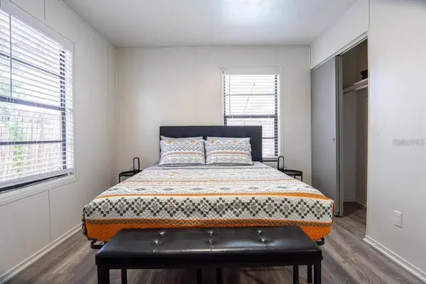 a bedroom with a bed and a window