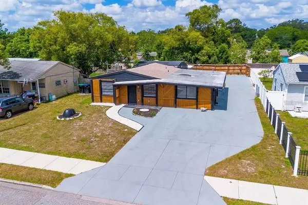 an aerial view of residential houses with outdoor space and parking