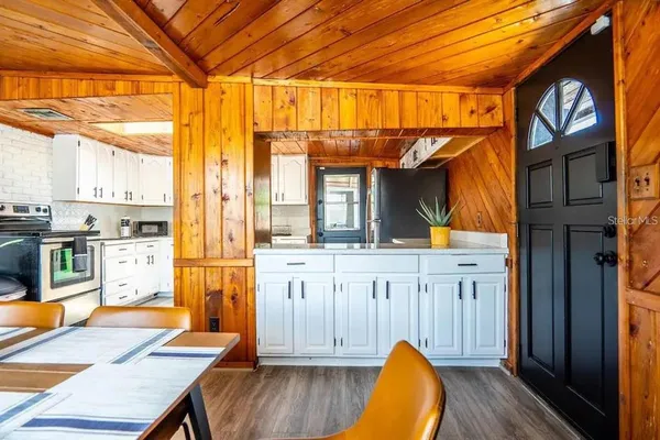 a kitchen with cabinets and wooden floor
