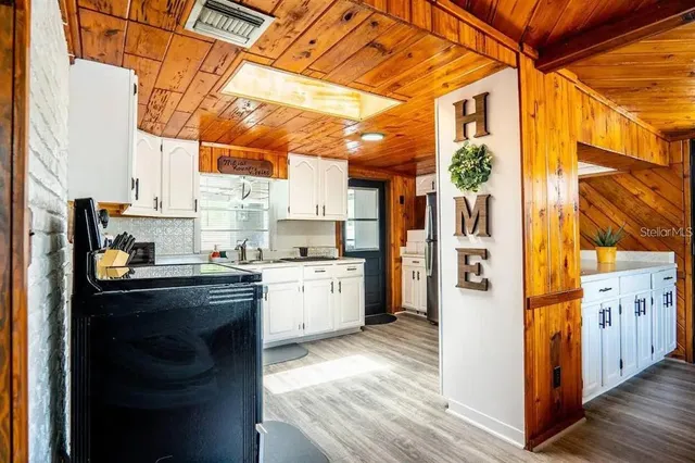 a kitchen with stainless steel appliances granite countertop a refrigerator and a stove
