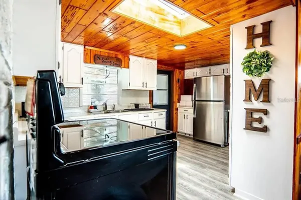 a kitchen with stainless steel appliances granite countertop a stove and a refrigerator