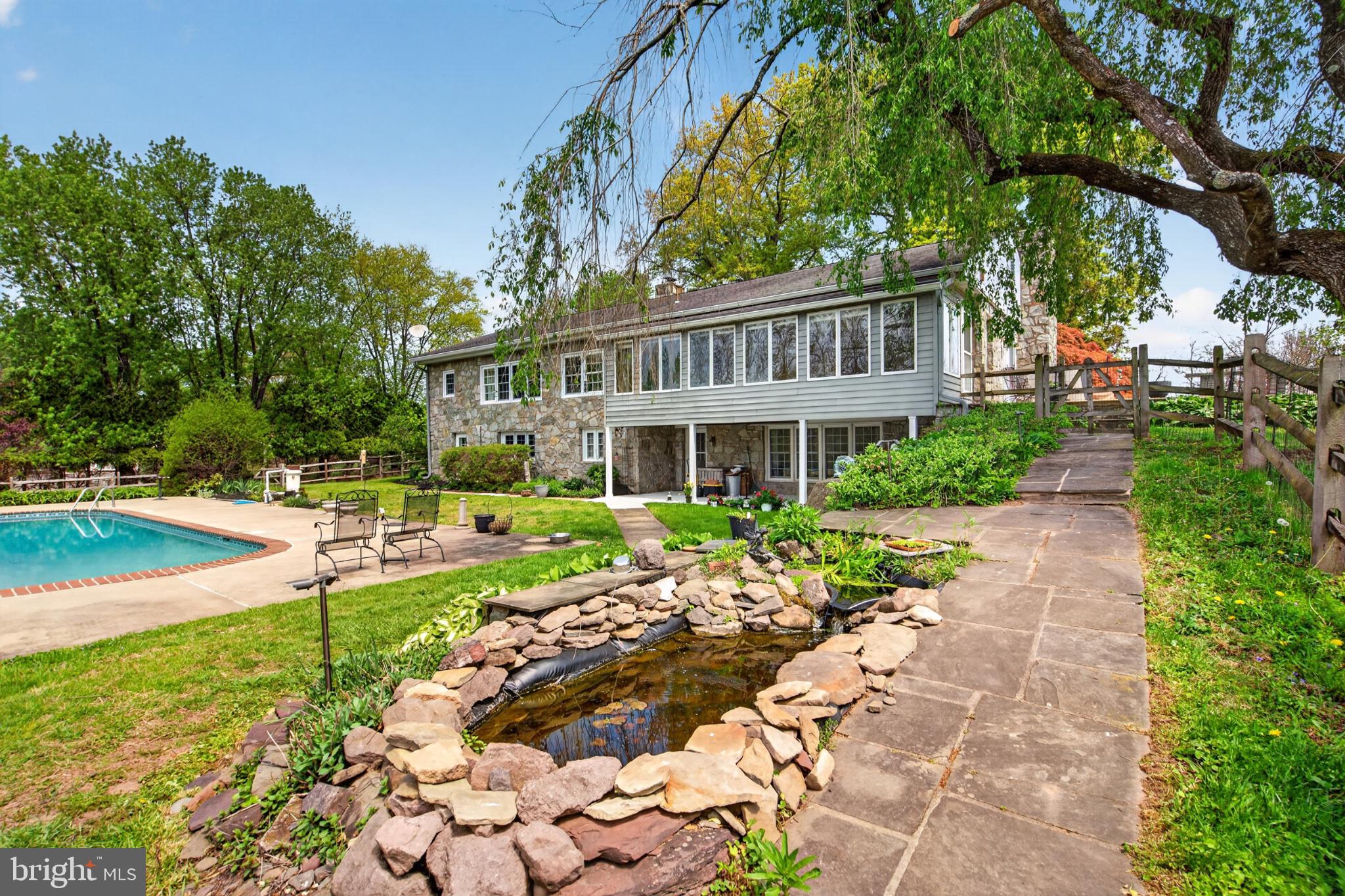 300 Sanatoga Road Pottstown, PA 19465 - Photo 9 of 79 Serene backyard oasis with poolside charm.