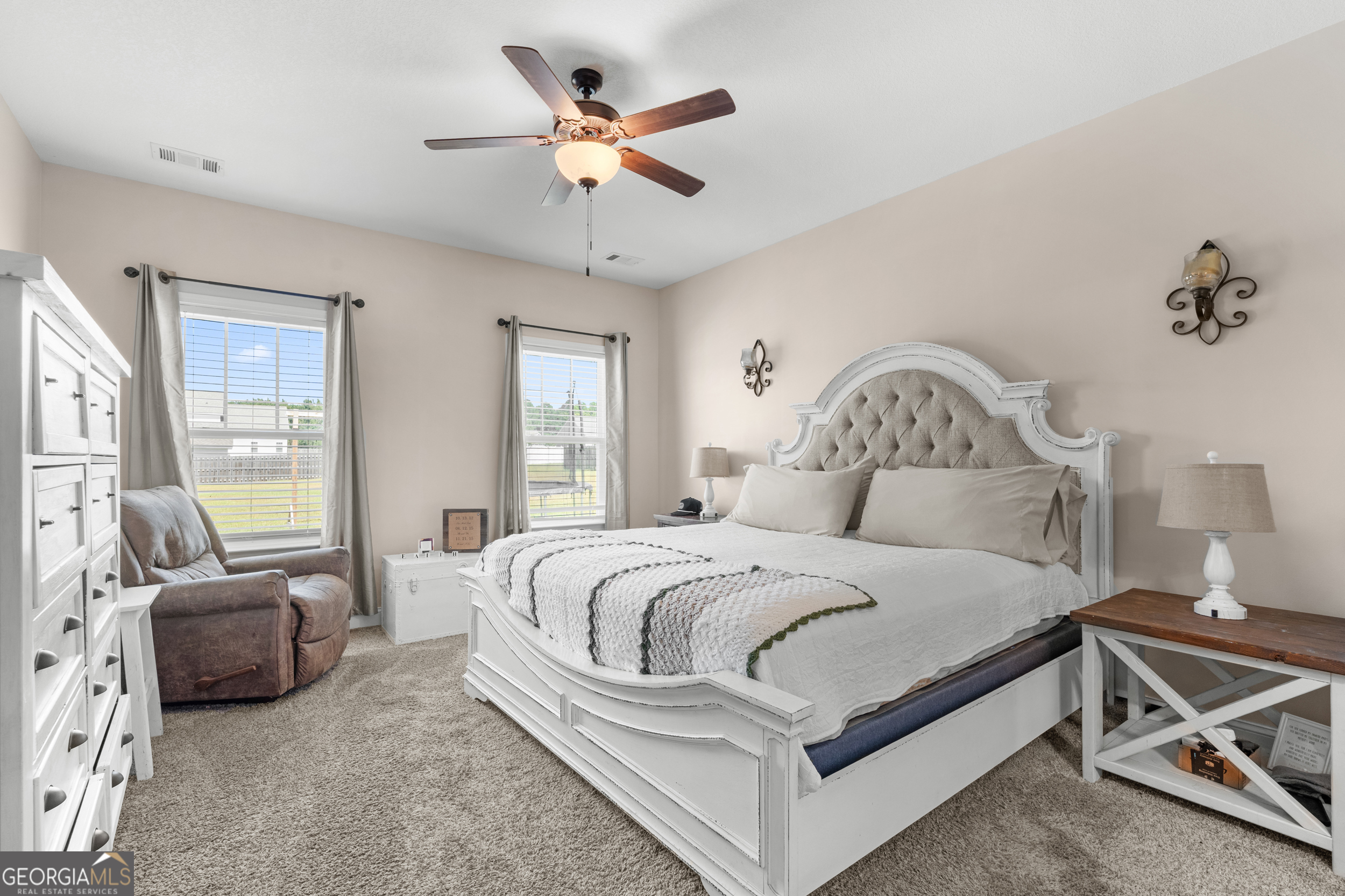 321 Farmington Road Statesboro, GA 30458 - Photo 12 of 24 a bedroom with bed and a chandelier