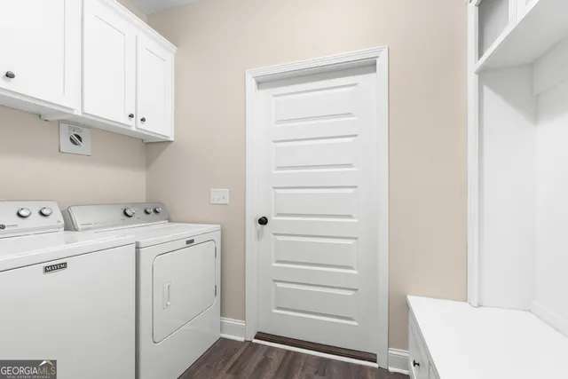 a view of cabinets and utility room with dryer and washer