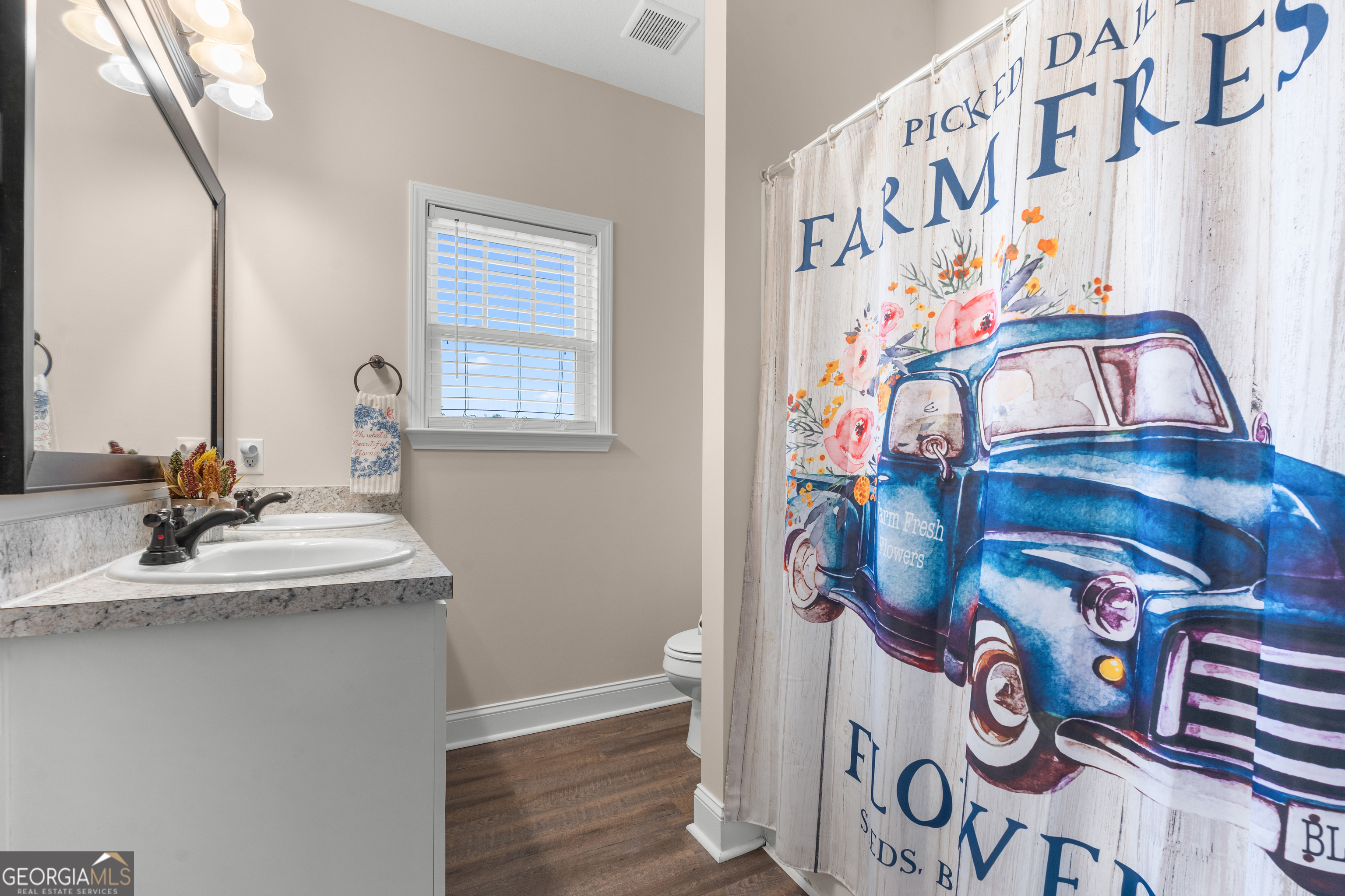 321 Farmington Road Statesboro, GA 30458 - Photo 19 of 24 a bathroom with a sink and a mirror with painted walls