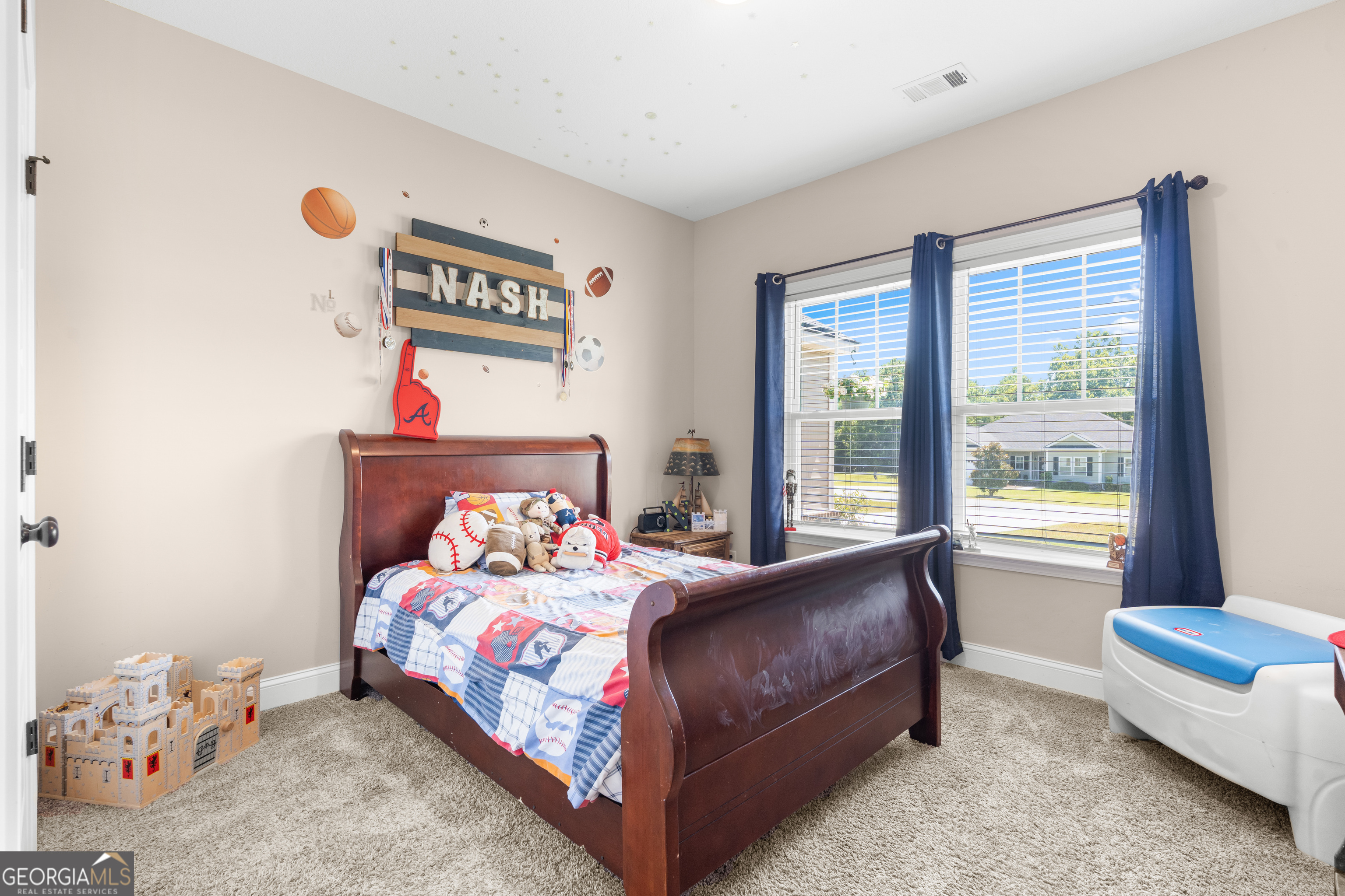 321 Farmington Road Statesboro, GA 30458 - Photo 21 of 24 a bedroom with a bed and a couch next to a window