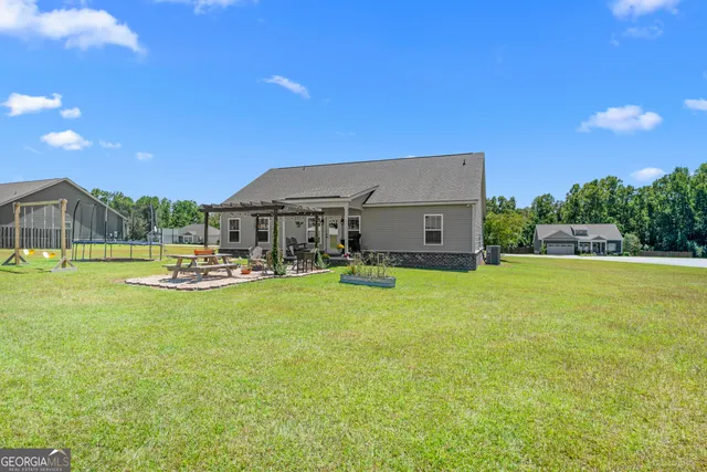 a view of a house with swimming pool and a yard
