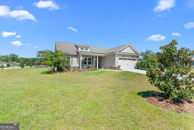 a front view of a house with garden