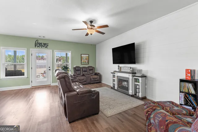 a living room with furniture and a flat screen tv