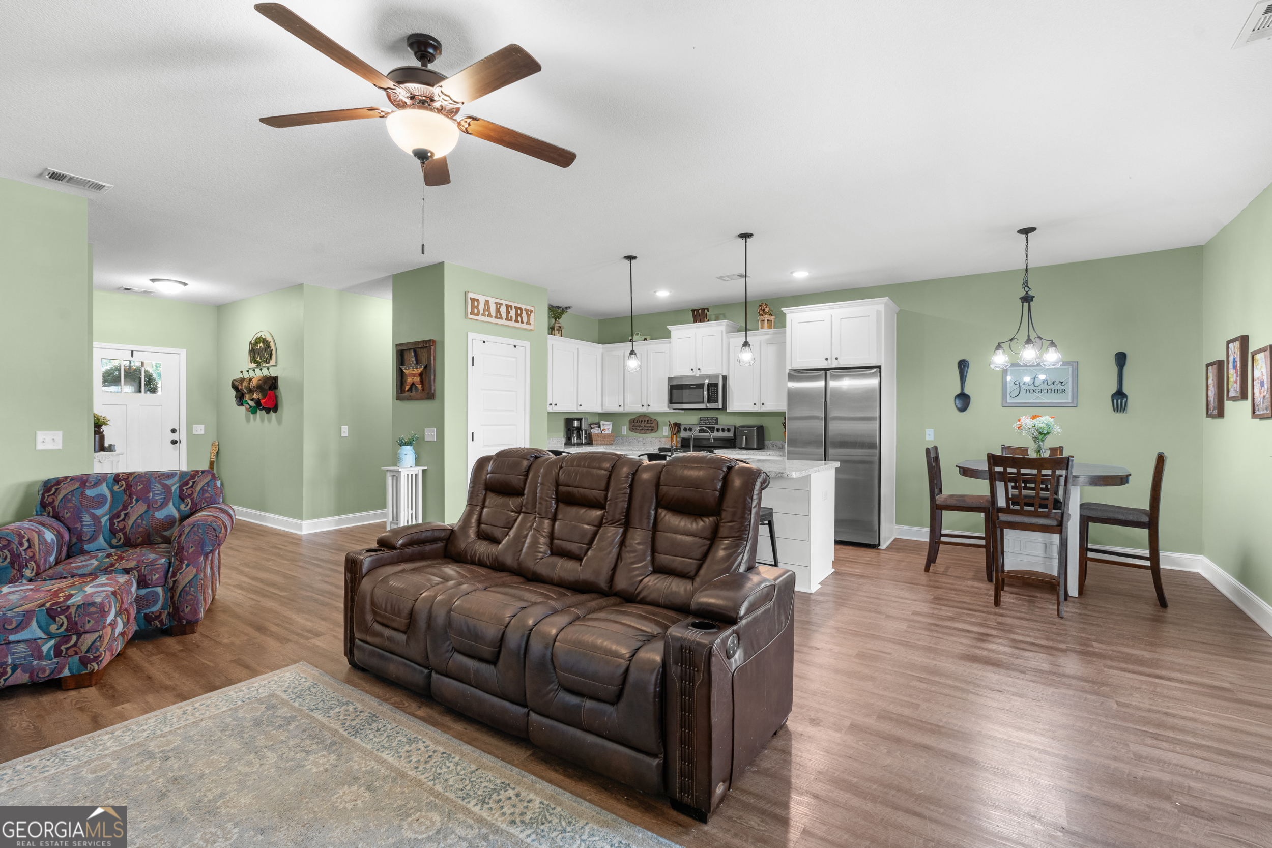 321 Farmington Road Statesboro, GA 30458 - Photo 8 of 24 a living room with furniture kitchen view and a dining table