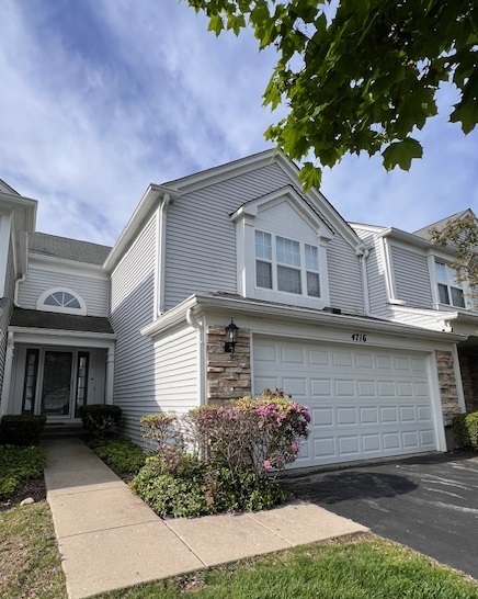 4716 Amber Circle Hoffman Estates, IL 60192 - Photo 2 of 14 a front view of a house with a garden