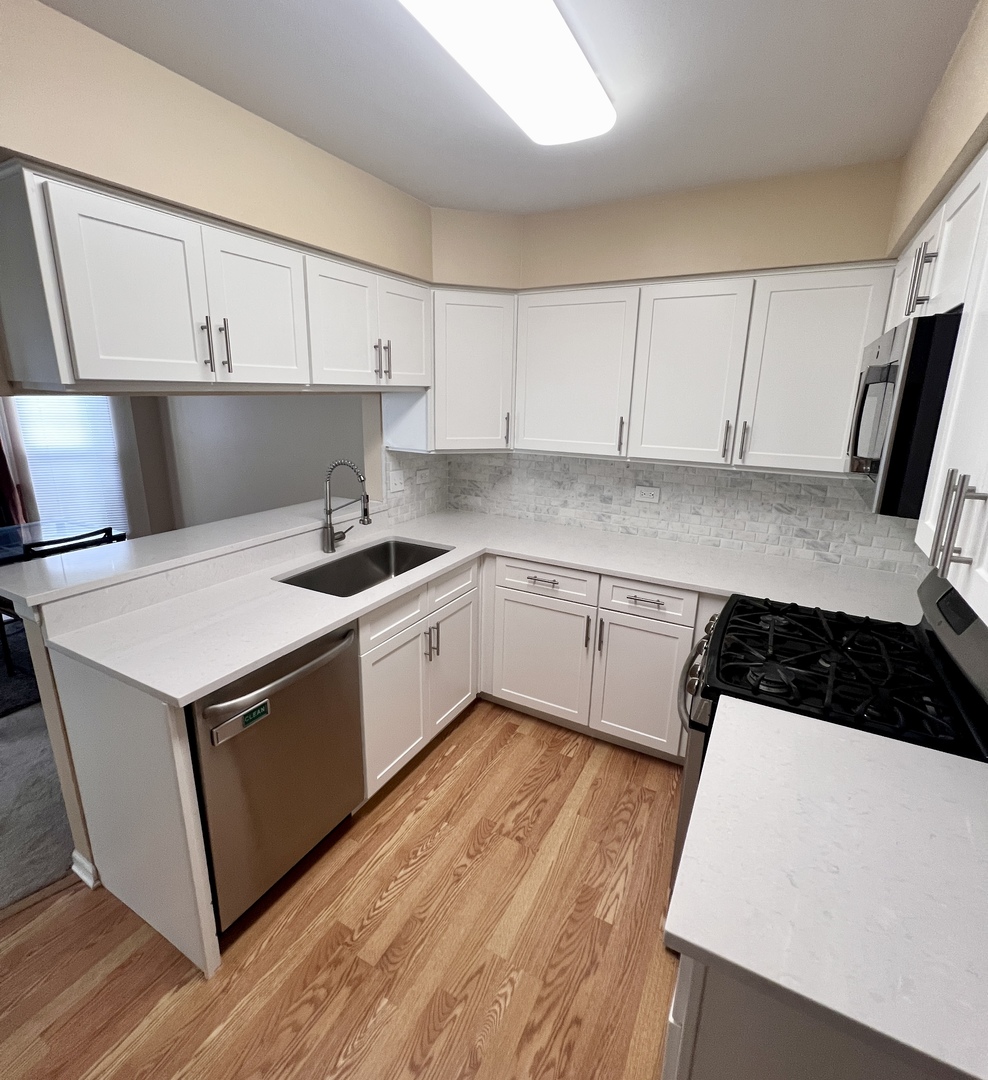 4716 Amber Circle Hoffman Estates, IL 60192 - Photo 6 of 14 a kitchen with a sink a stove and cabinets