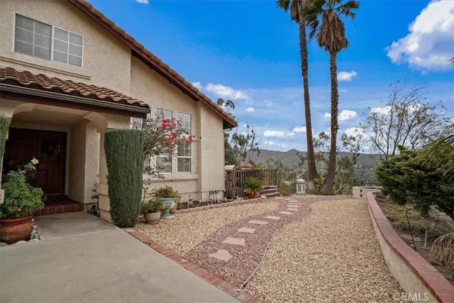 a view of a house with potted plants in front of it
