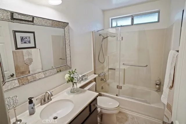 a bedroom with bed and a chandelier