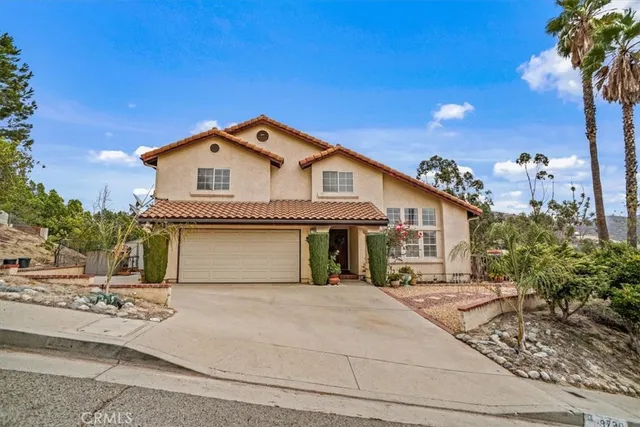 a front view of a house with a garden and yard