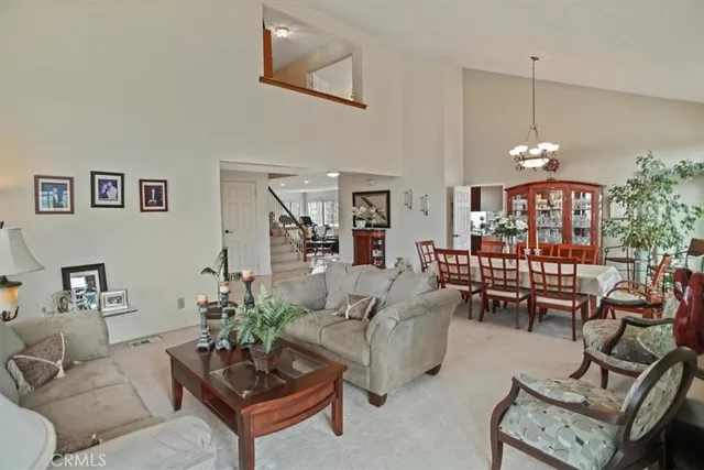 a living room with furniture a rug and a chandelier
