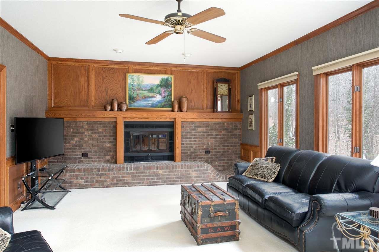 205 Trotters Ridge Drive Raleigh, NC 27614 - Photo 11 of 25 a living room with furniture a fireplace and a flat screen tv