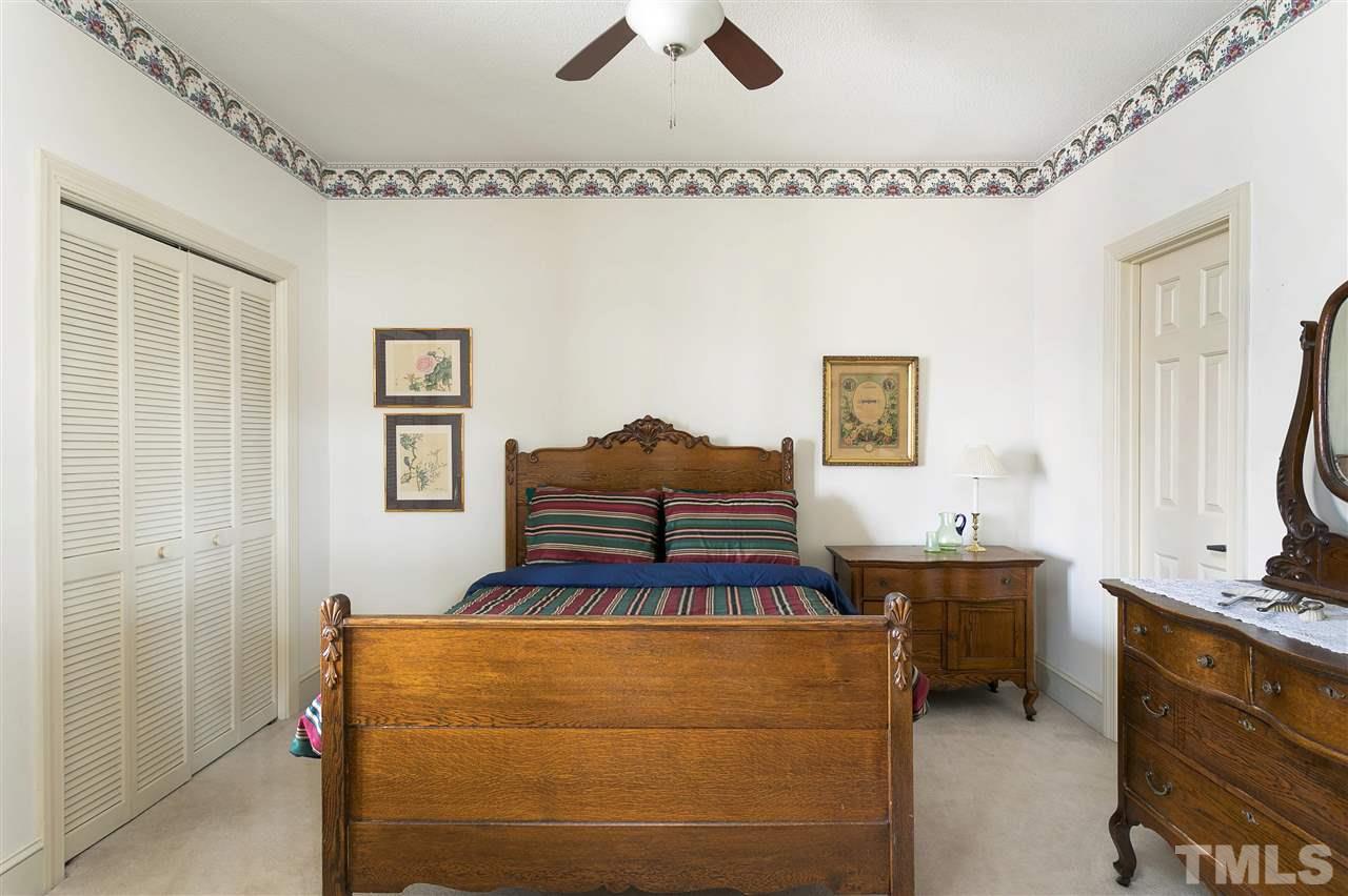 205 Trotters Ridge Drive Raleigh, NC 27614 - Photo 12 of 25 a bedroom with a bed and a chandelier