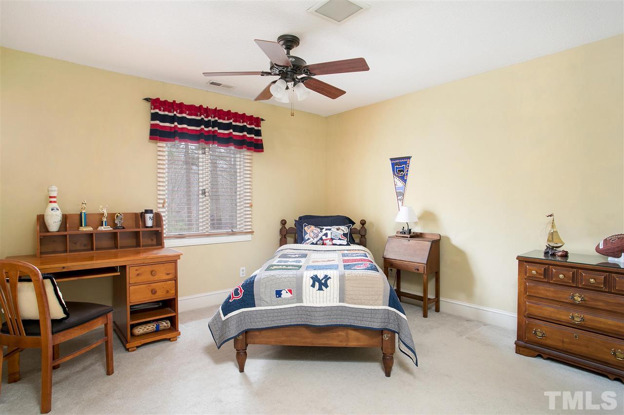 205 Trotters Ridge Drive Raleigh, NC 27614 - Photo 17 of 25 a bedroom with a bed and a chandelier