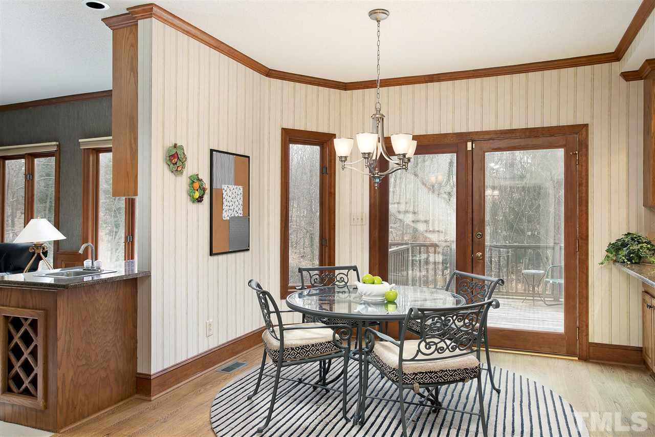 205 Trotters Ridge Drive Raleigh, NC 27614 - Photo 8 of 25 a dining room with furniture a chandelier and wooden floor