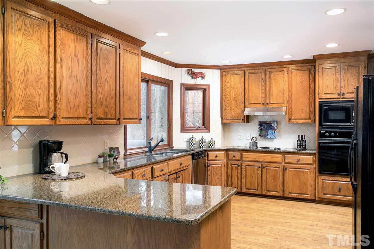 205 Trotters Ridge Drive Raleigh, NC 27614 - Photo 9 of 25 a kitchen with stainless steel appliances granite countertop a sink a stove and cabinets