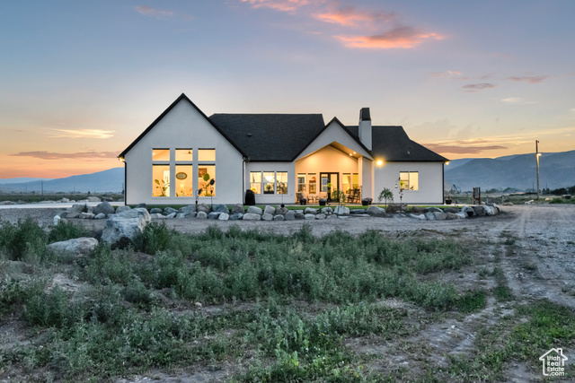 1952 Highway 118 Monroe, UT 84754 - Photo 70 of 88 Back of house at dusk with a chimney, stucco siding, and a mountain view