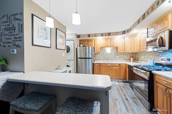 a kitchen with a table chairs sink and cabinets
