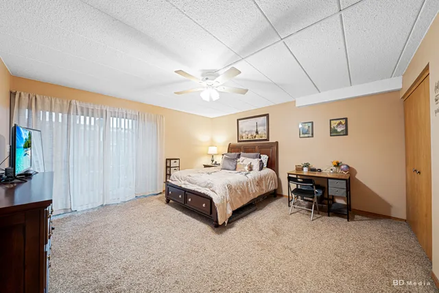 a spacious bedroom with a bed and a chandelier